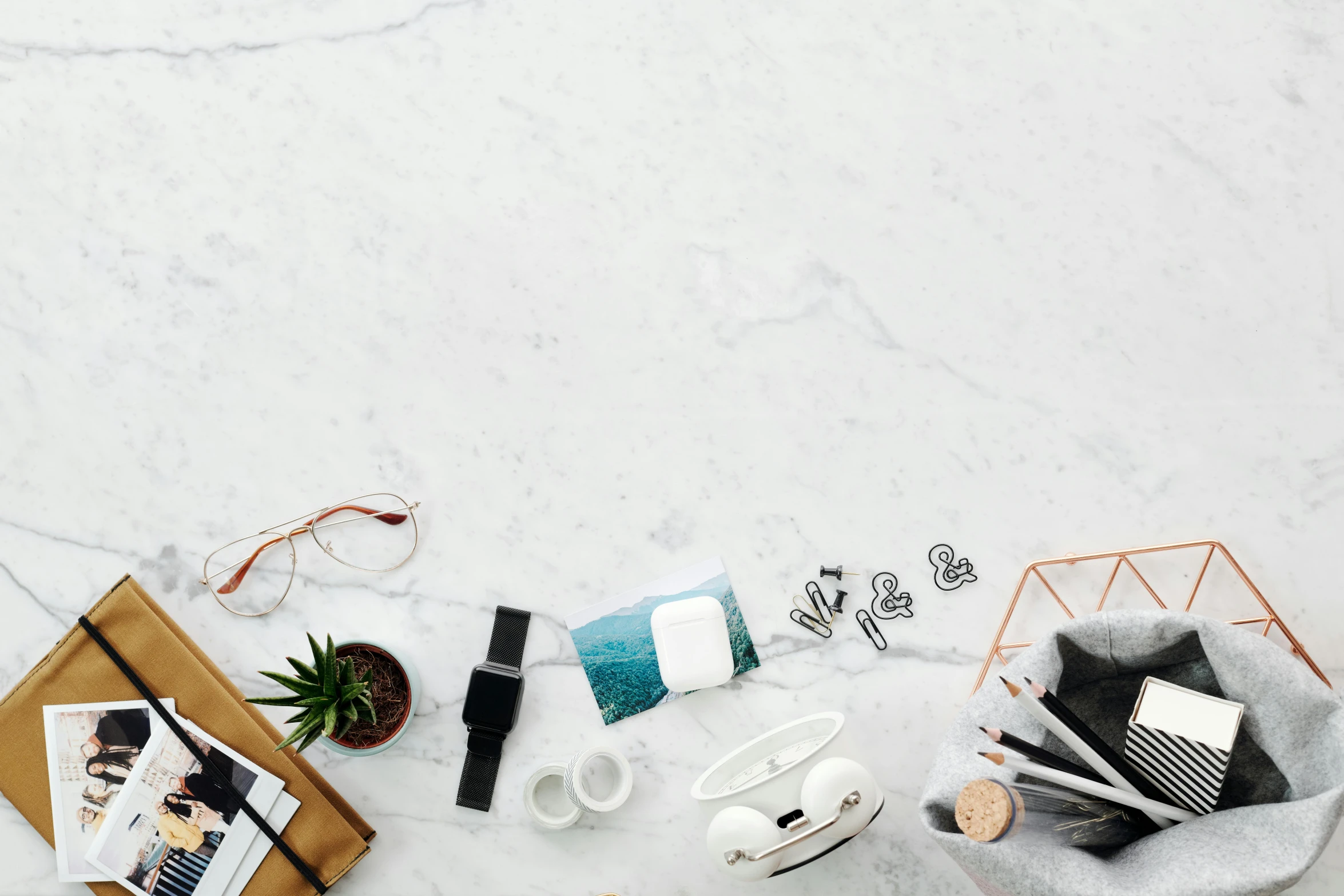 various accessories on a white table including hair combs, makeup brush, and hair clips