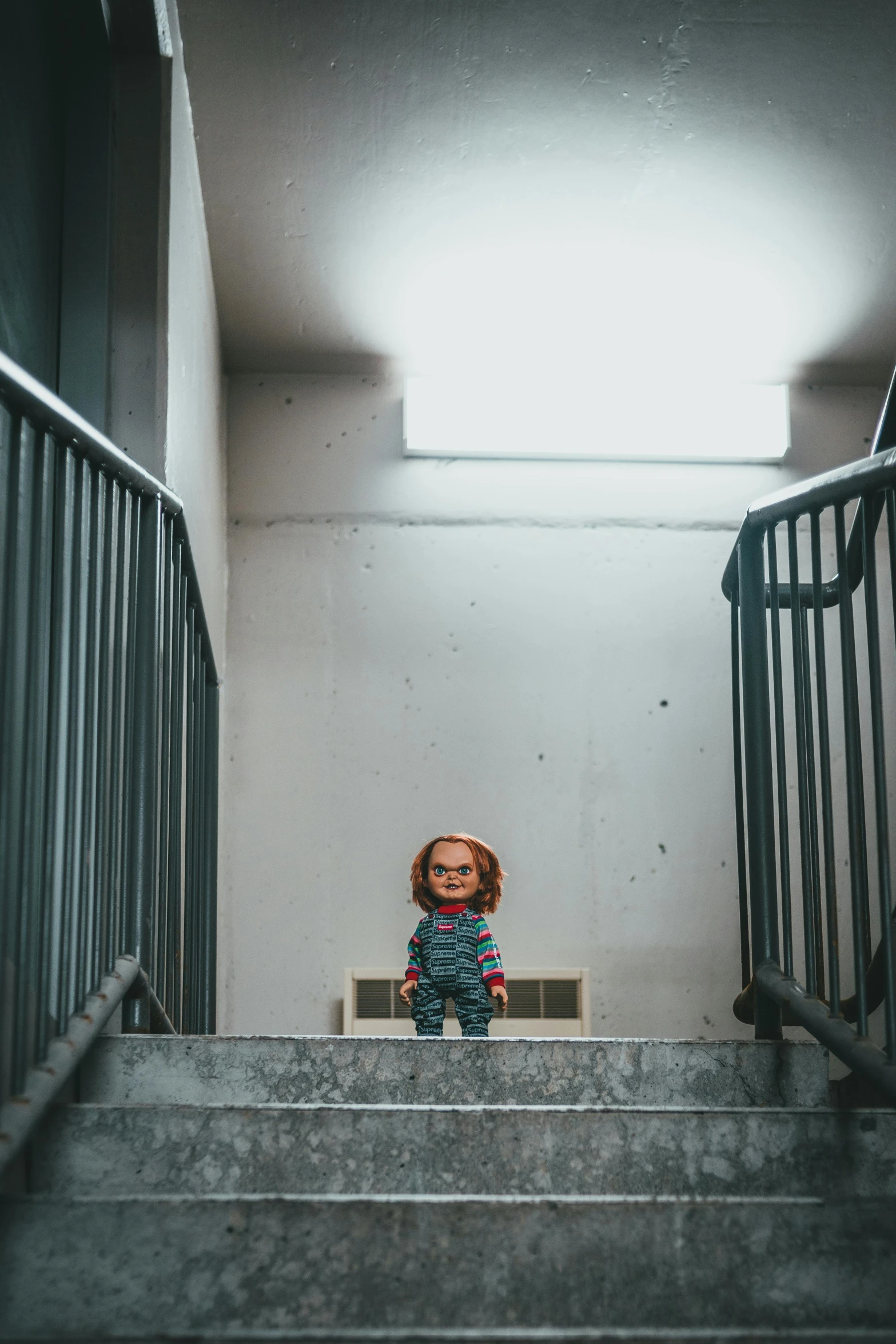 the little girl is standing on a staircase