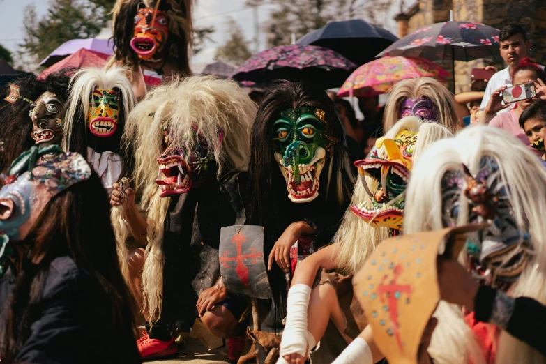 people dressed up in colorful painted masks standing together