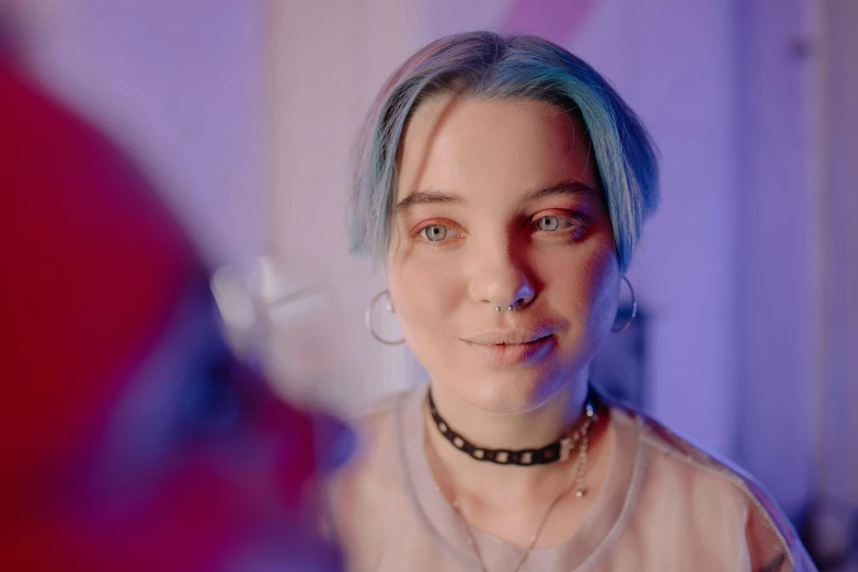 a woman with dyed blue hair wearing a black choker