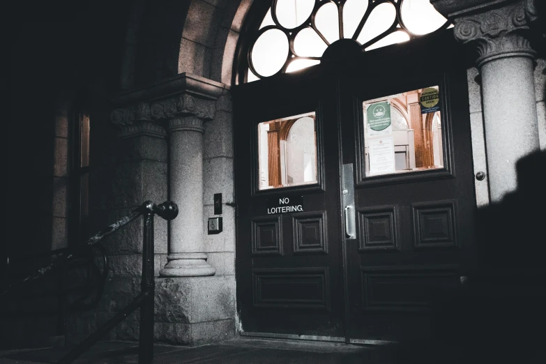 a black and white po with a lit window in the background