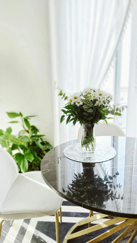 vase of flowers sit on top of the marble table