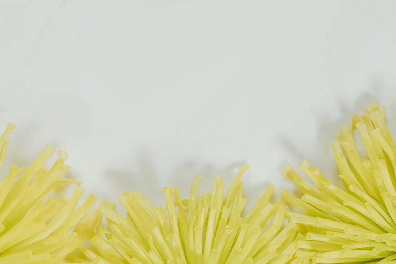 there are yellow flowers that have been arranged on the table