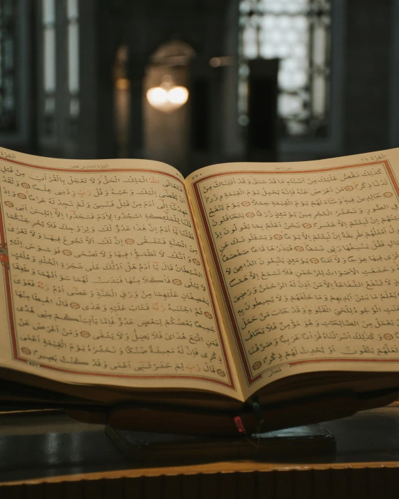 an open book sitting on top of a glass table