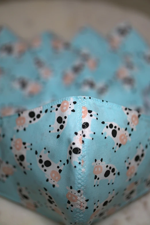 the blue cloth has a pattern and flower