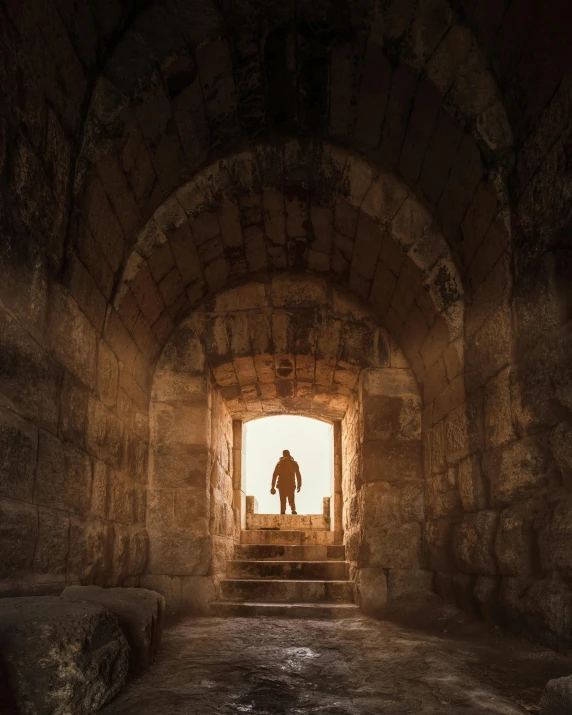 a person walking down some stairs at an archway