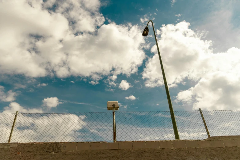 an industrial street light is above a basketball court