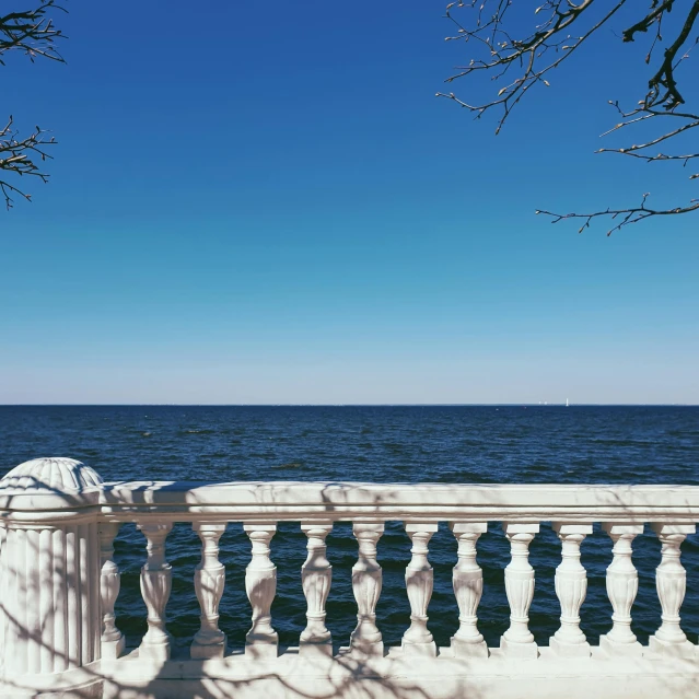 the railing over the water looks like it is made of snow