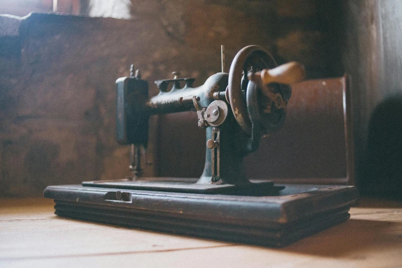 an old black sewing machine sitting on top of a table