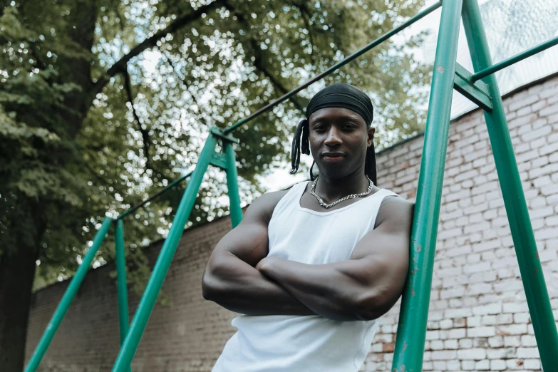 a person posing for a po in front of some tall green bars