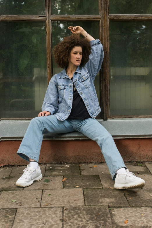 a woman is sitting on the windowsill in front of her