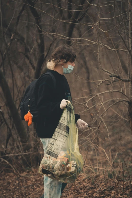 a woman wearing a mask is carrying plastic bags and a bag