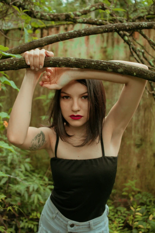 a woman is holding a nch near her head