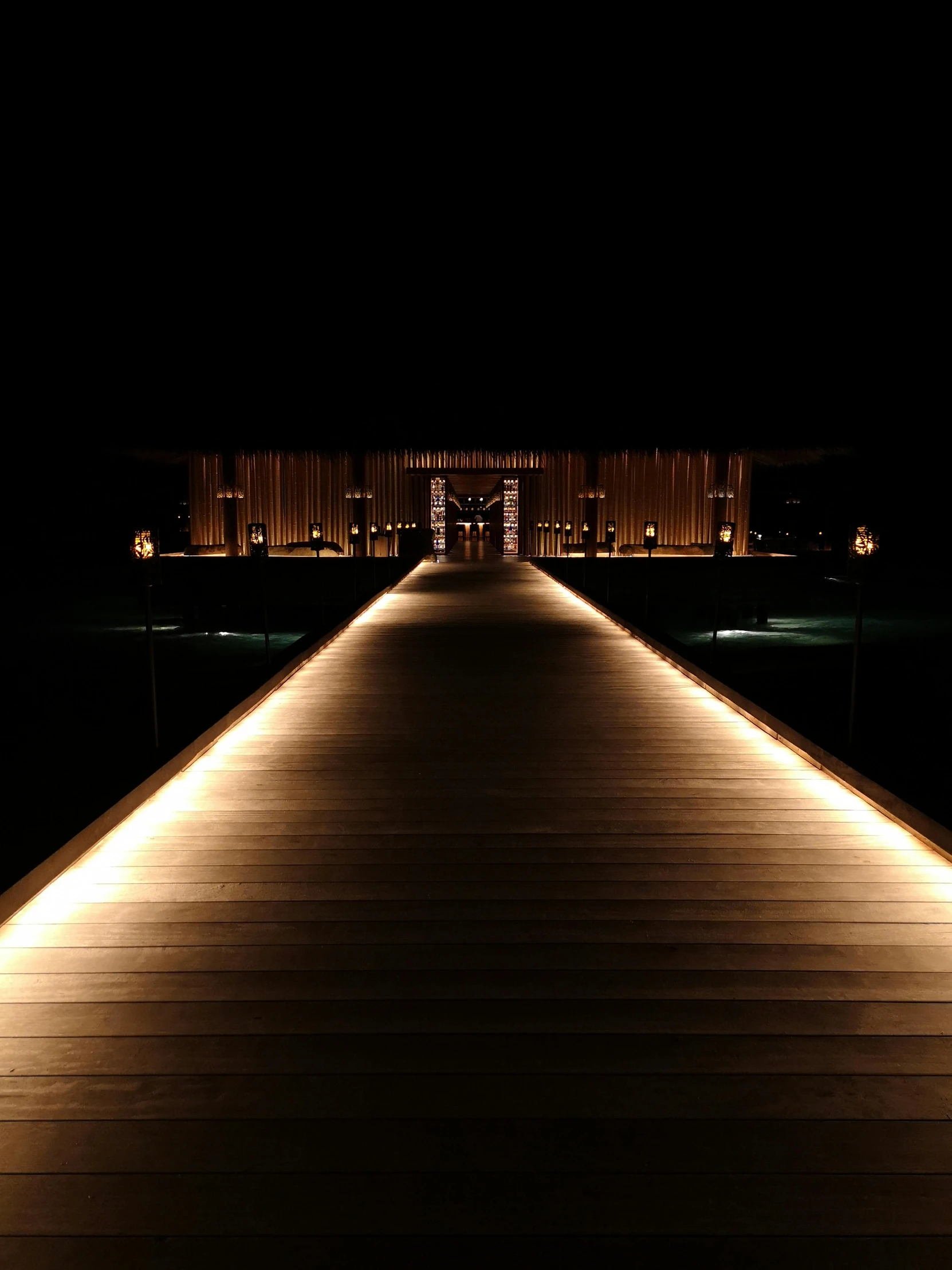 this is a walkway that is illuminated at night