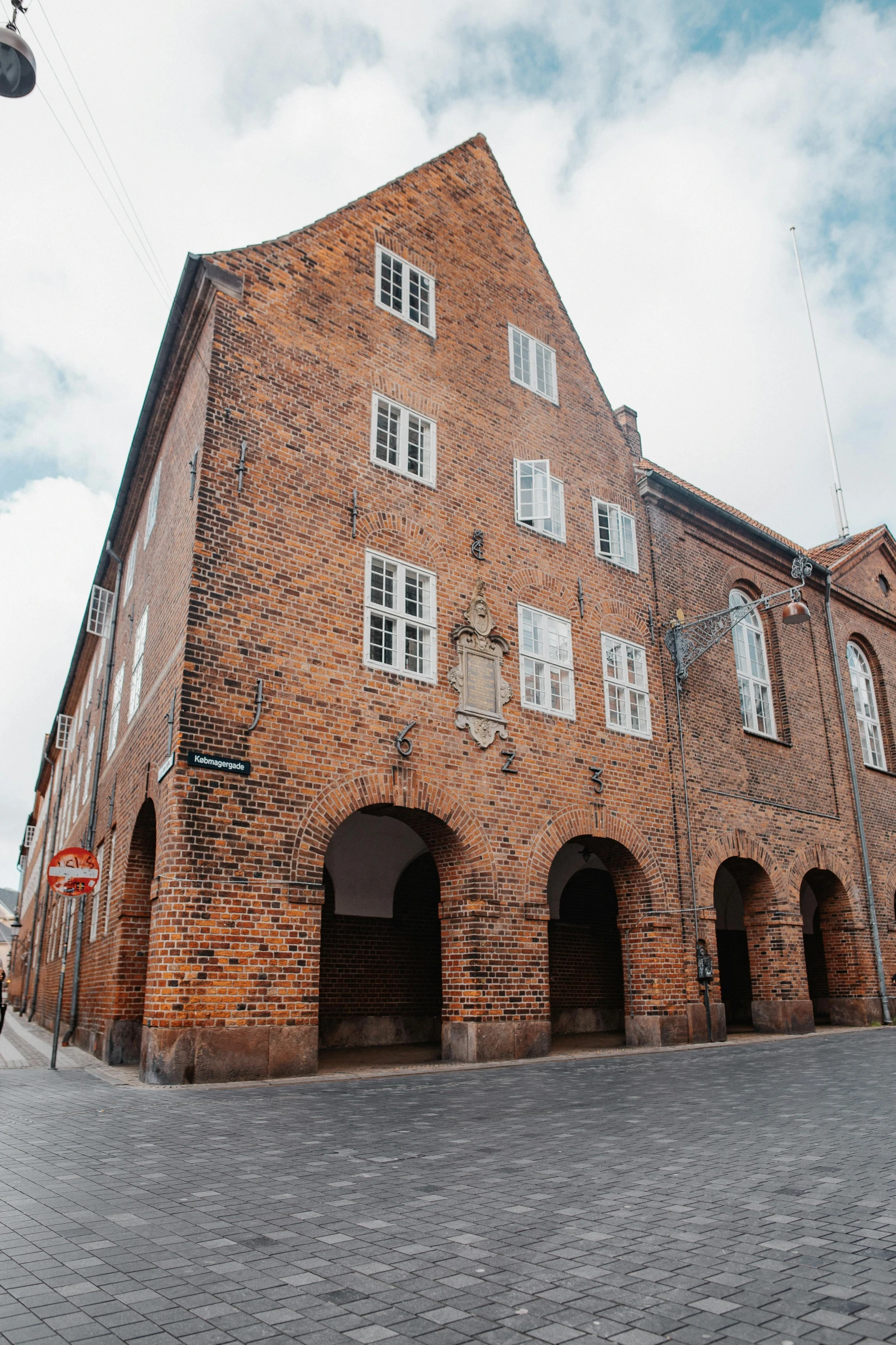 a building made of brick in the middle of the street