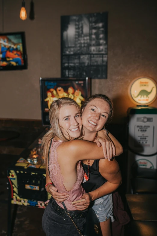 two women hugging at the table for a po