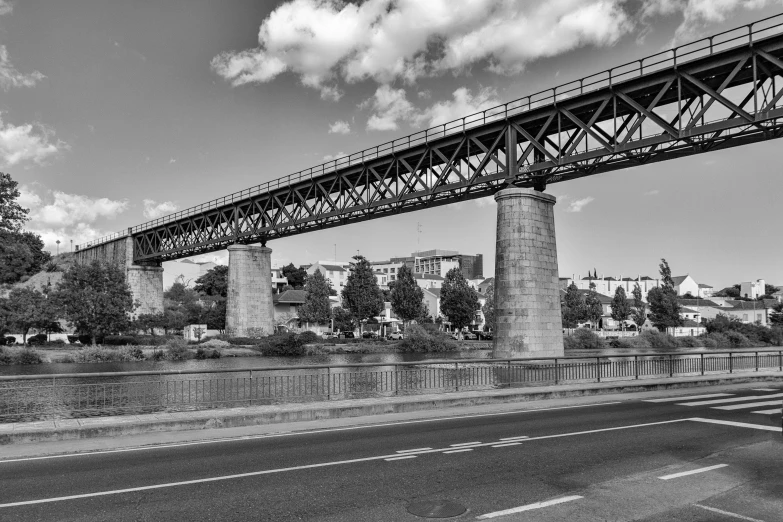 a black and white picture of a train bridge