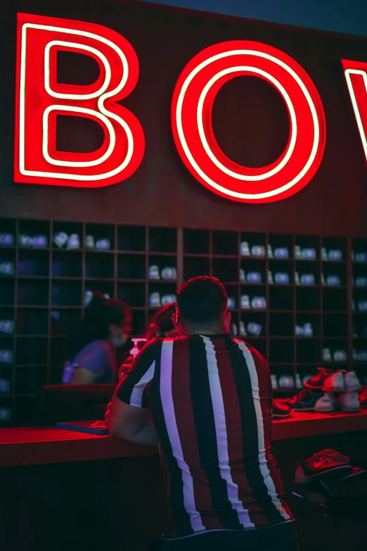 the back of a man wearing a black and white striped shirt