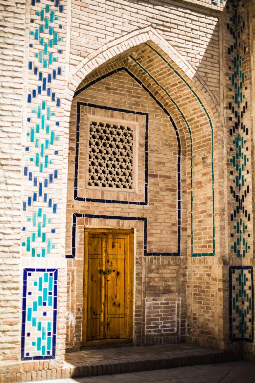 an ornate arch that has a wooden door