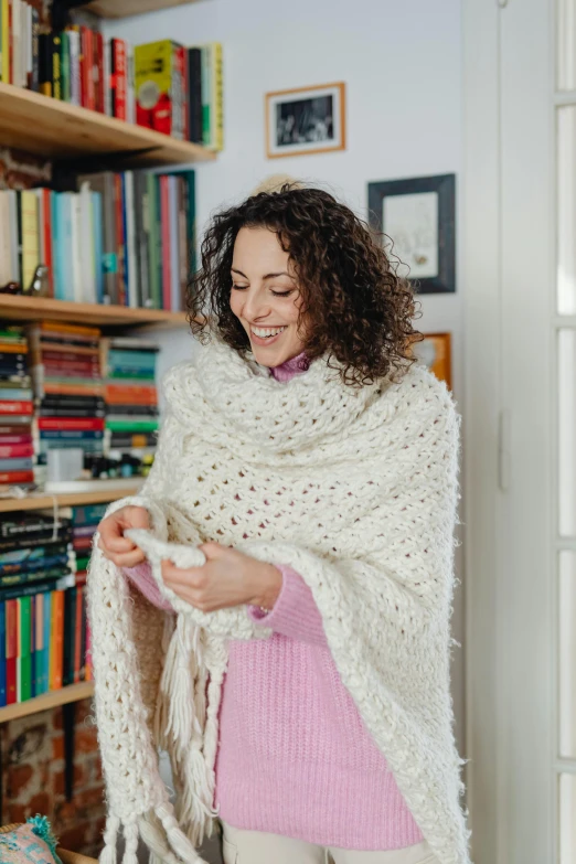 woman in a white blanket with her hands folded up