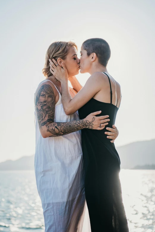 a couple kissing by the ocean during their engagement