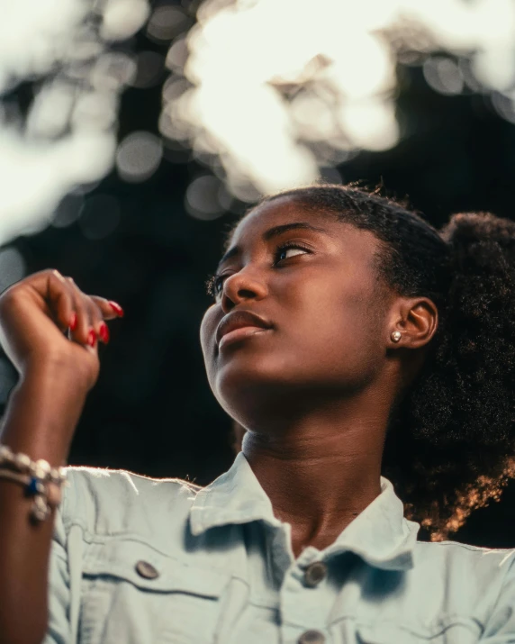 a woman looking up at soing with her eyes closed