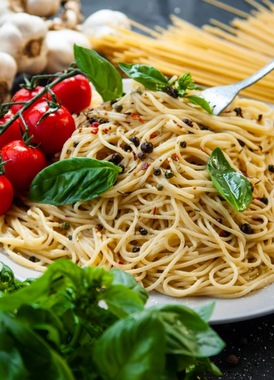 the plate is full of pasta and cherry tomatoes