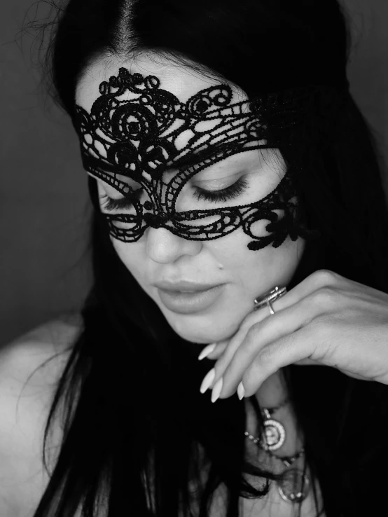 black and white pograph of a woman wearing a masquerade