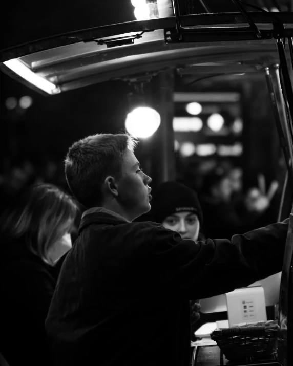 black and white pograph of a boy working in a machine