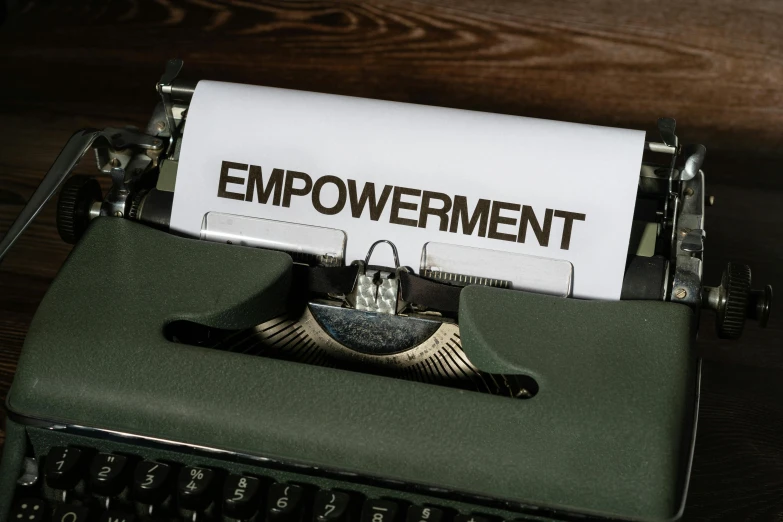 a typewriter with an inscription,'involvement in the job or process of employment, has the word employment highlighted