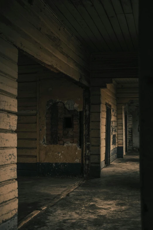 an empty hallway has wood and brick walls