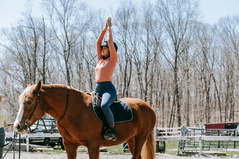 the woman is balancing her horse's rope