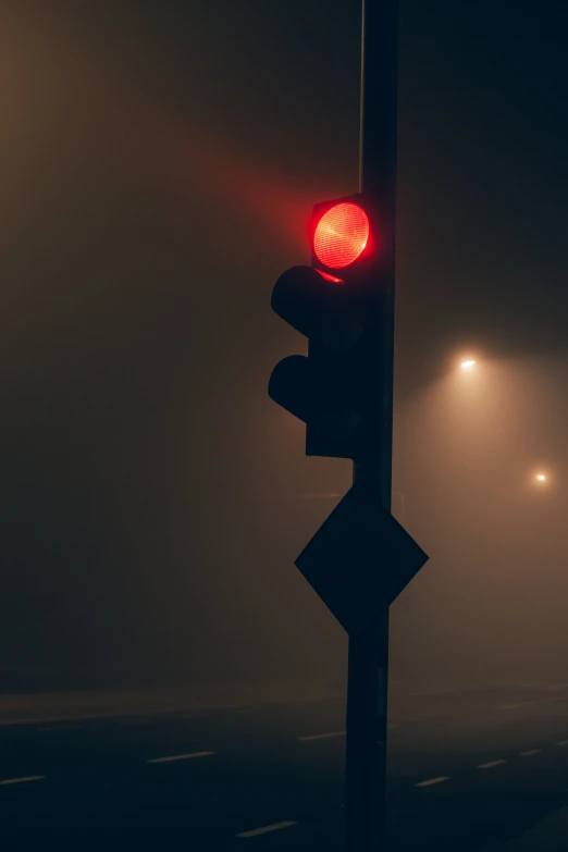 a stop light sitting on the corner of a road