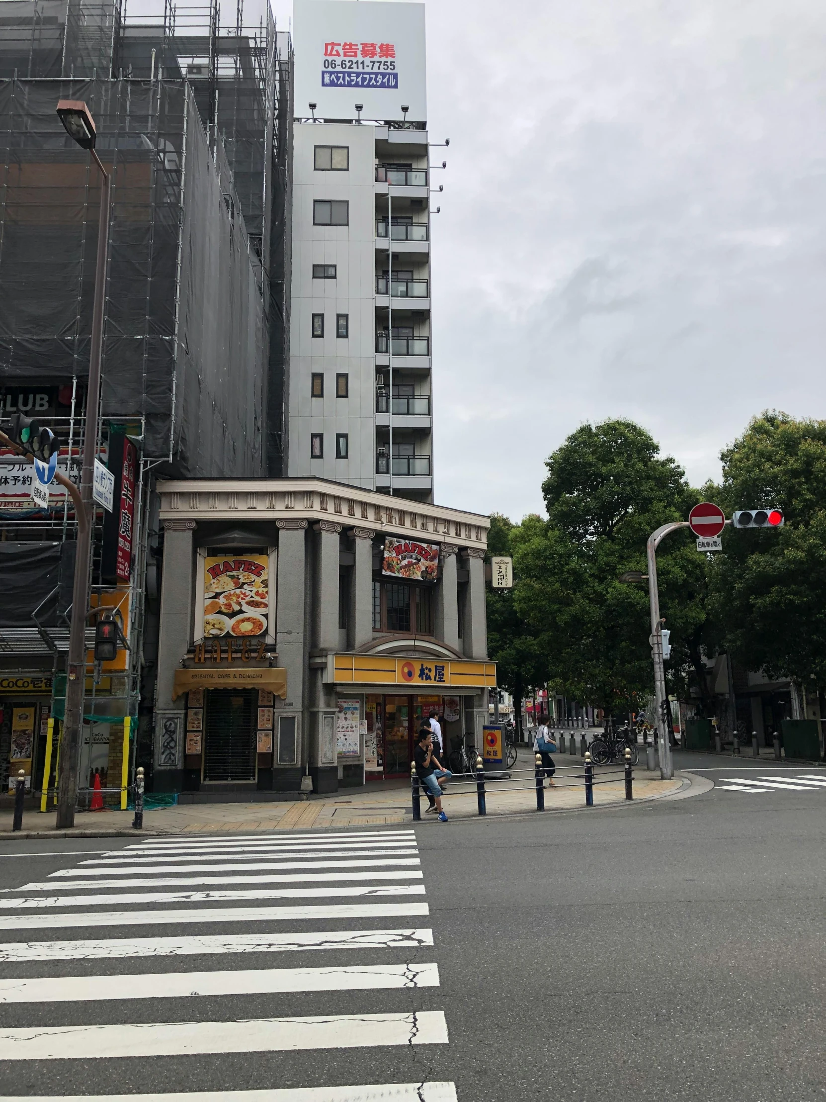 a street corner with a large building under construction