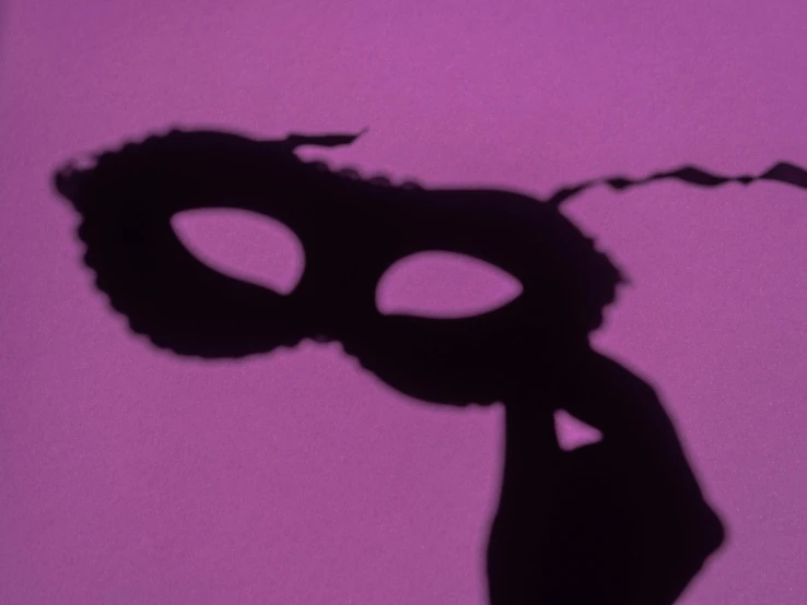 a silhouette of a face with dark makeup on it