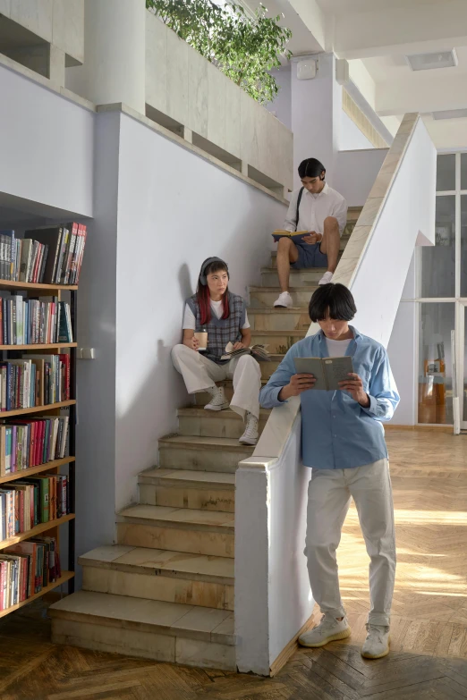 four students are sitting on the stairs together