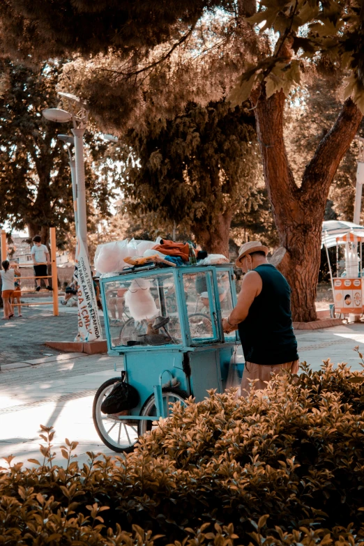 a man on the side of the road filling bottles on the cart