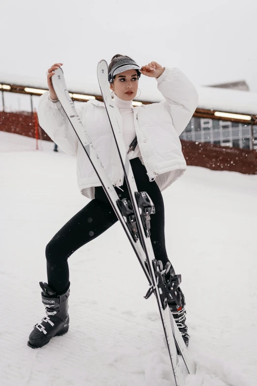 a woman is posing for a picture wearing skis in the snow