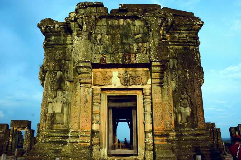 a group of carvings on the front of a large stone temple