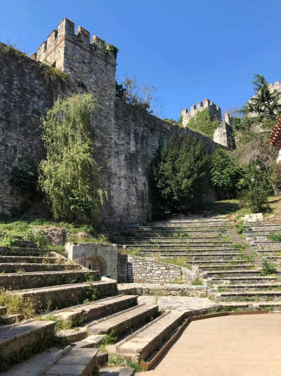 stone staircases in front of a castle and trees