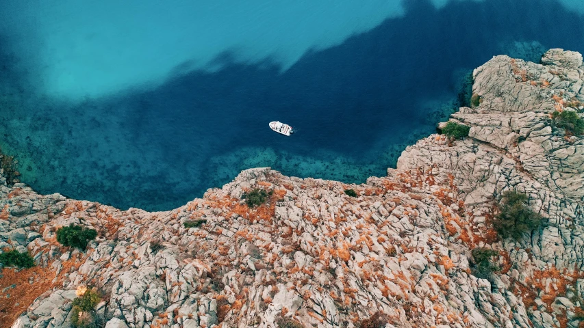 aerial view of a blue lagoon in the middle of mountains