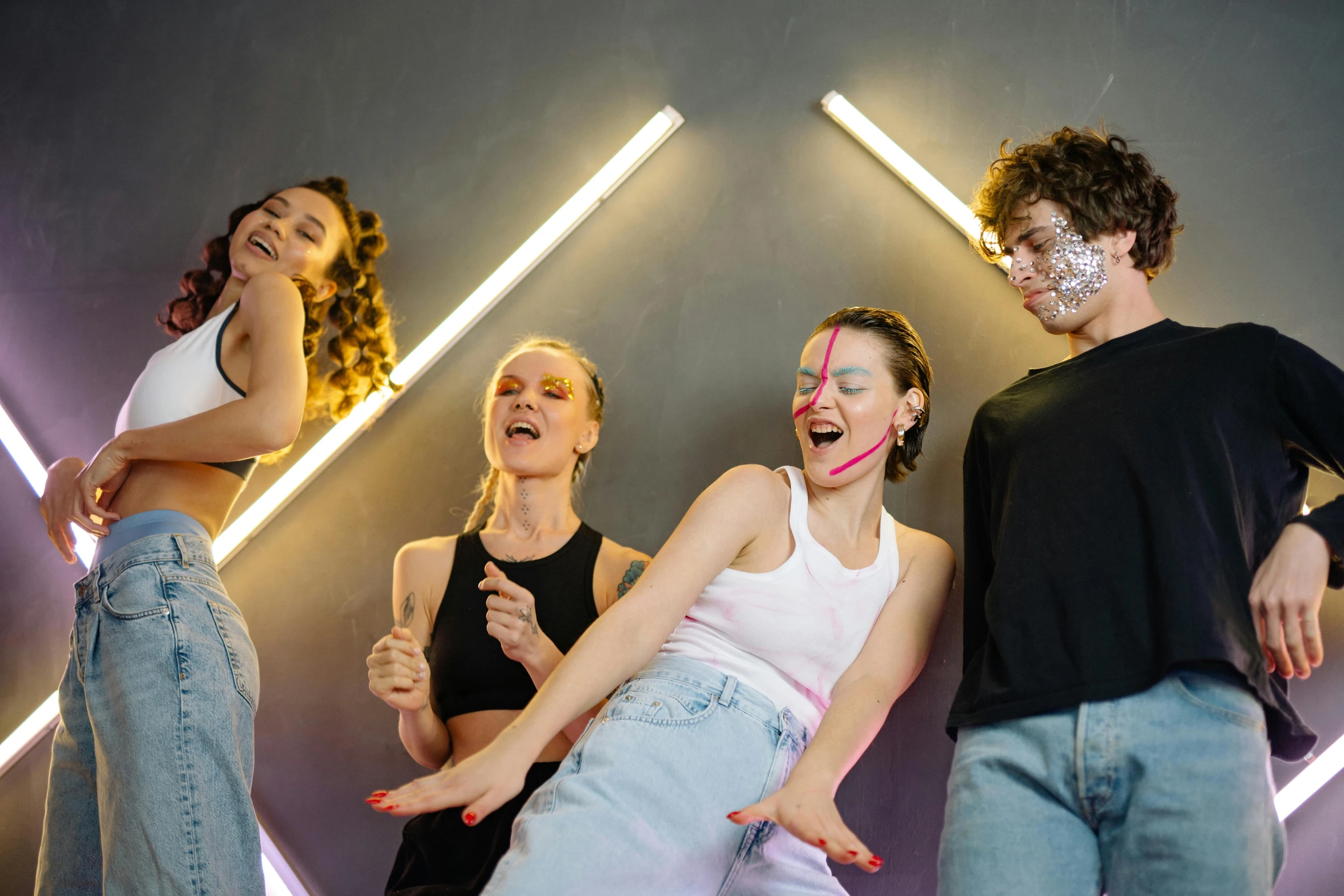 four young women in a group with their faces painted like faces