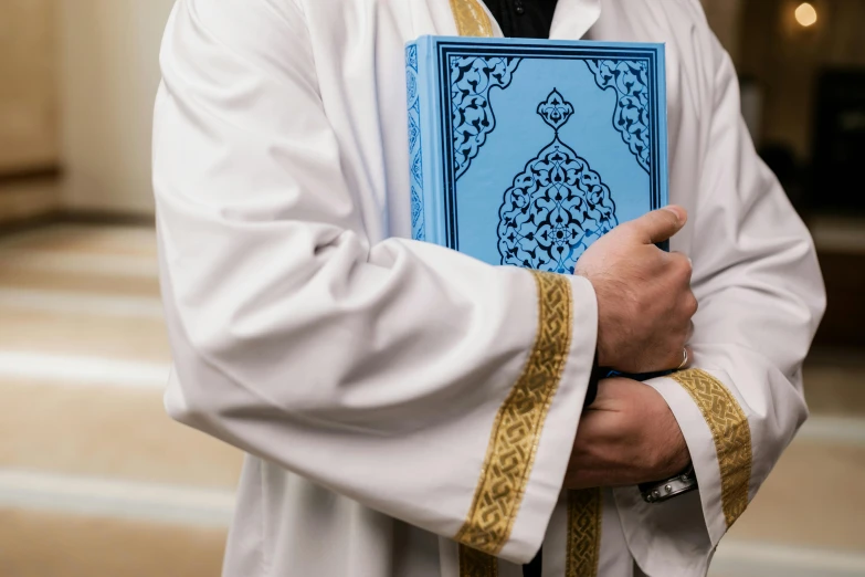 a person with a blue book in his hands