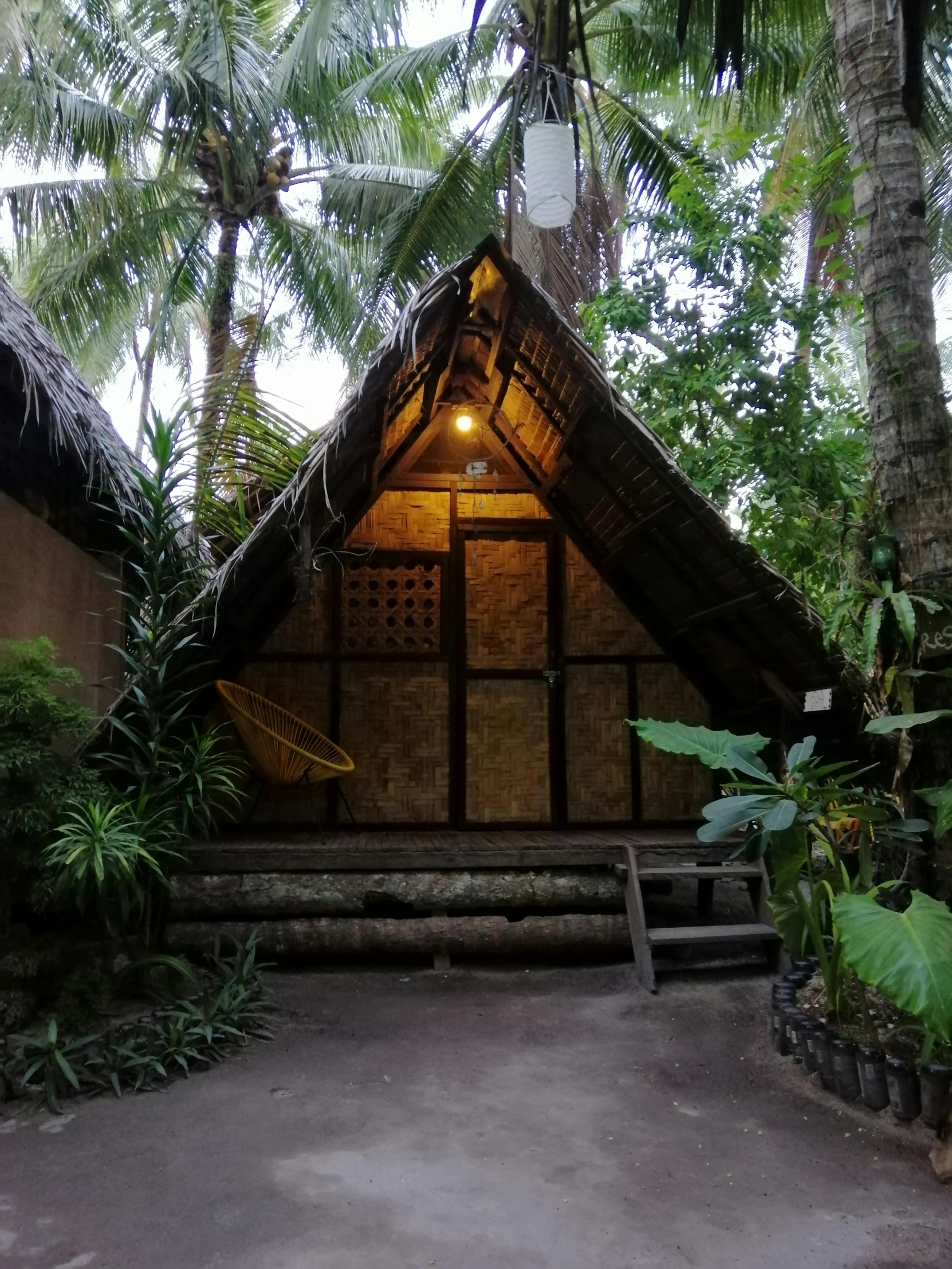 an outside view of some type of structure with a hammock attached to it