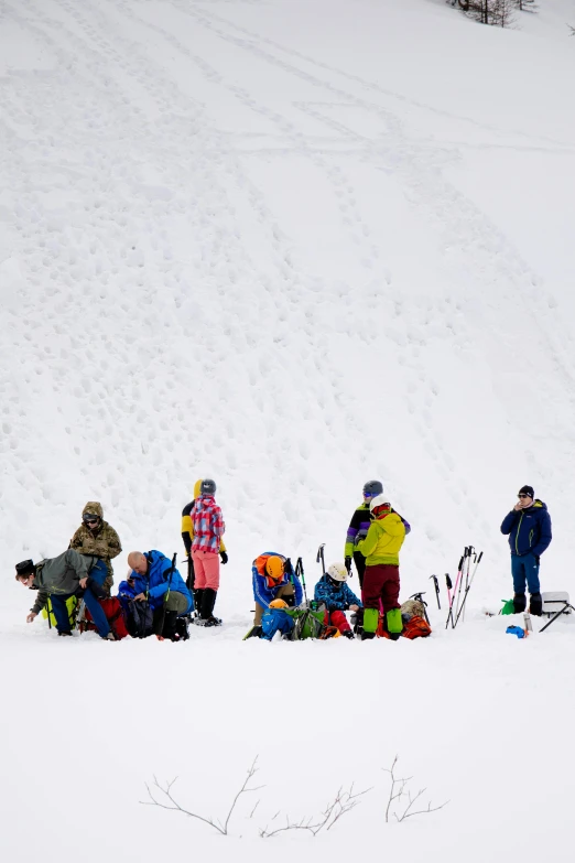 a line of people standing around with skis and poles