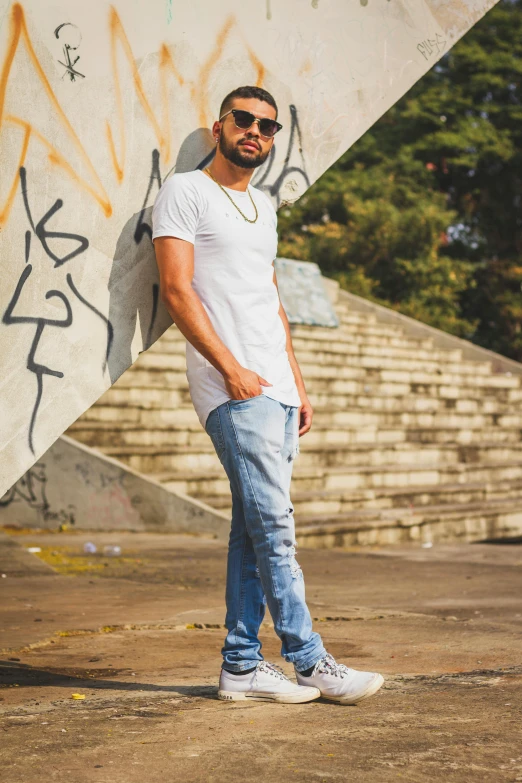 a man standing in front of graffiti covered steps