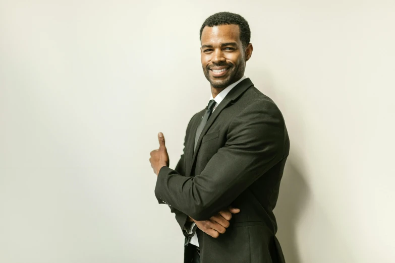 an african american man is standing in front of a wall