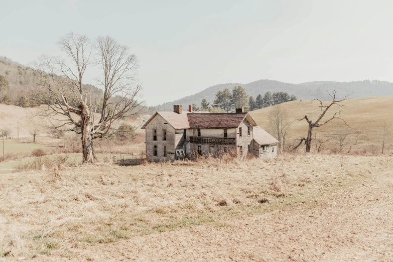 an old building sits in the middle of a field