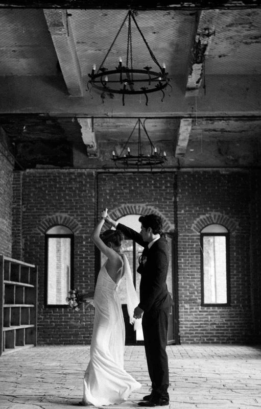 a couple in black and white wedding po holding a piece of paper