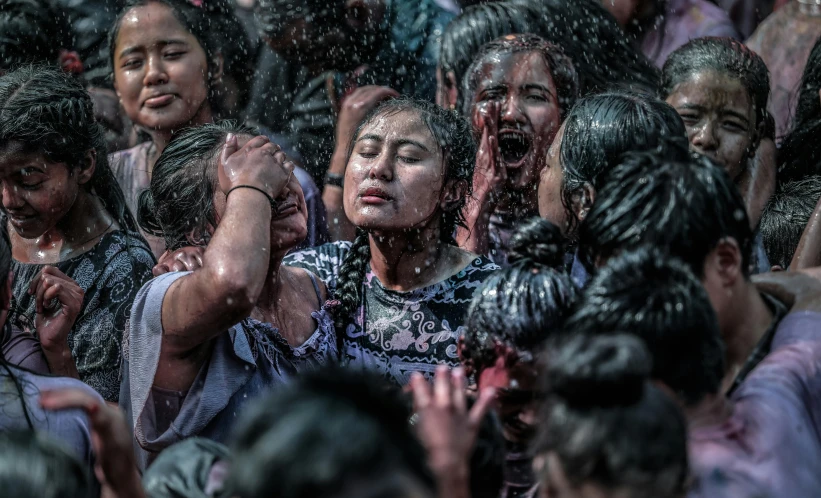 a crowd of people in the pouring water